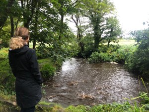 Author on a walk looking a creek