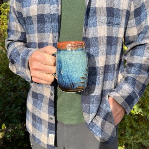 man holding a mug of tea