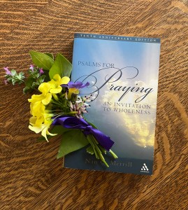 a bouquet of weeds/wildflowers next to the book Psalms for Praying