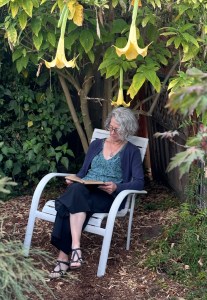 author reading in her garden
